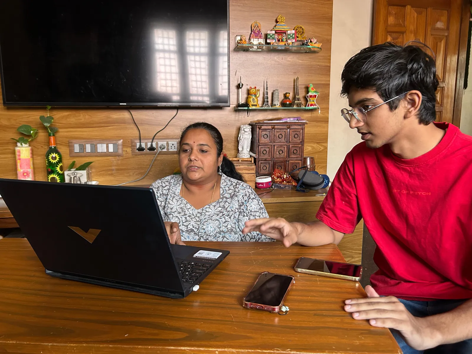 A farmer tries the prototype at home while I take notes