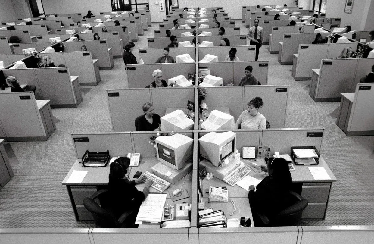 Black and white photo of a crowded open-plan office
